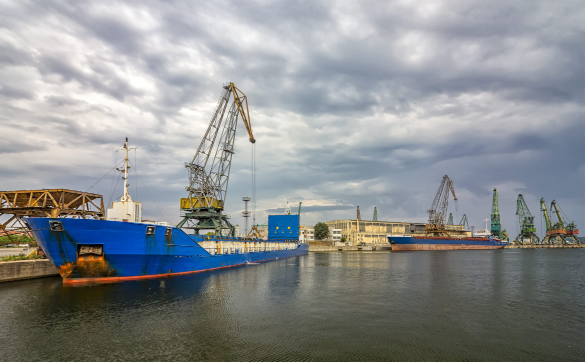 Loading raw materials with the crane to the warehouse on the trading ship of the port city, Varna, Bulgaria